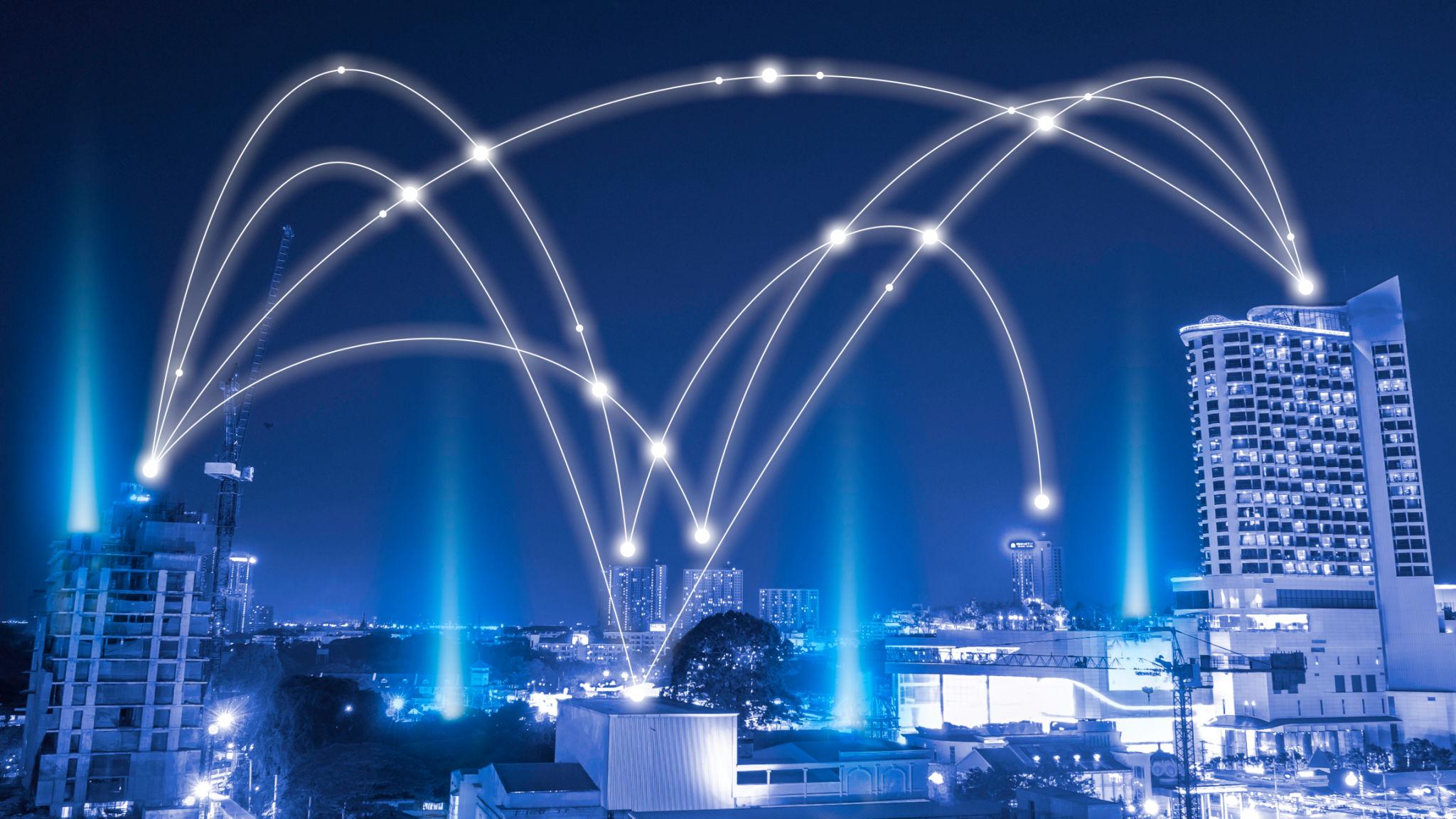 Team gathered around a laptop in an office.